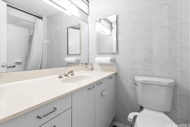 bathroom featuring toilet, tile walls, and vanity