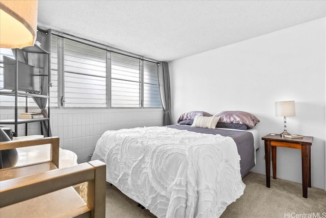 carpeted bedroom featuring a textured ceiling