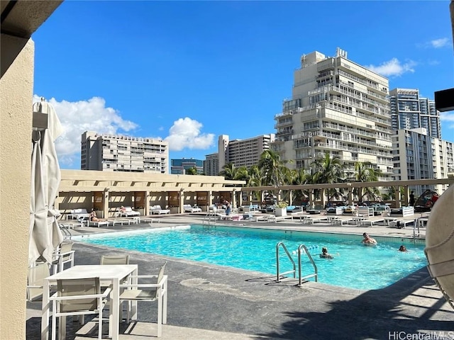 pool with a view of city and a patio area