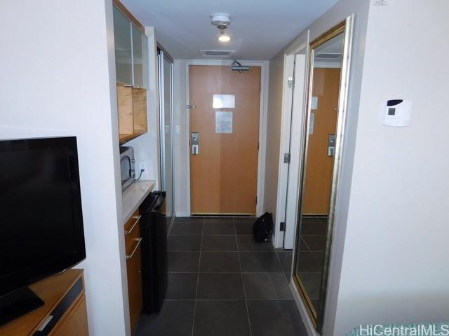 corridor with dark tile patterned flooring