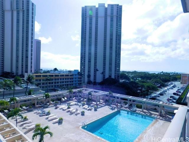 view of swimming pool with a view of city