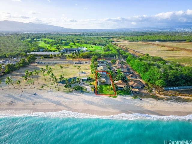 bird's eye view featuring a water view and a beach view