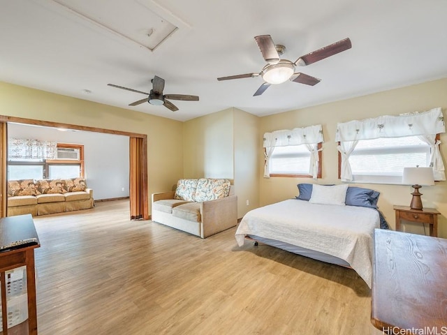 bedroom with light wood finished floors and a ceiling fan