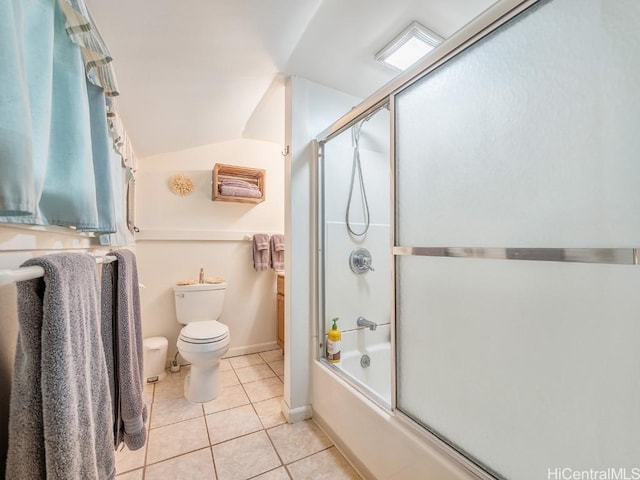 bathroom featuring lofted ceiling, tile patterned flooring, toilet, baseboards, and combined bath / shower with glass door