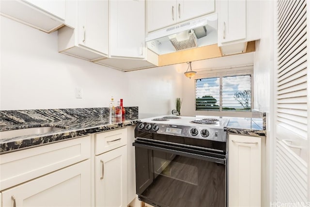 kitchen with under cabinet range hood, black / electric stove, and white cabinets