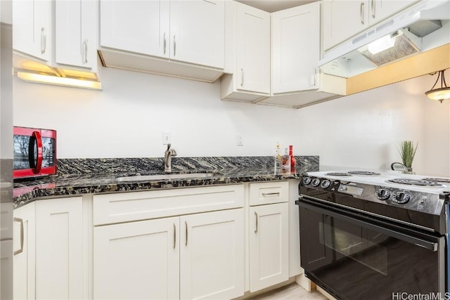 kitchen with under cabinet range hood, electric range, a sink, white cabinetry, and dark stone countertops