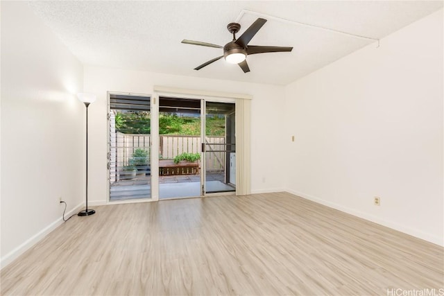 unfurnished room featuring a ceiling fan, baseboards, a textured ceiling, and light wood finished floors