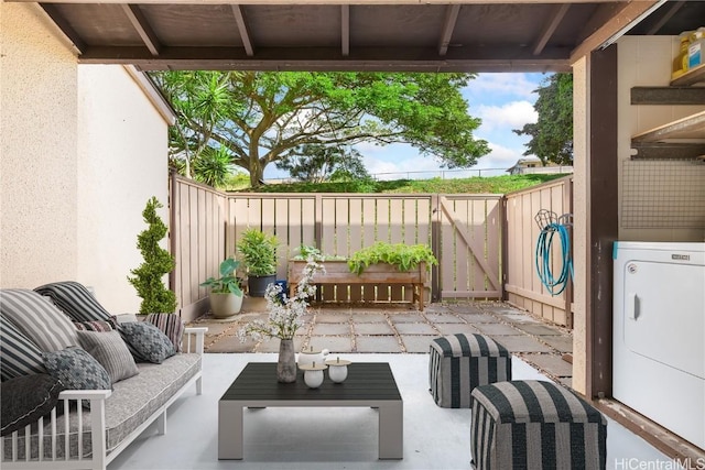 view of patio / terrace with outdoor lounge area, a gate, washer / dryer, and fence