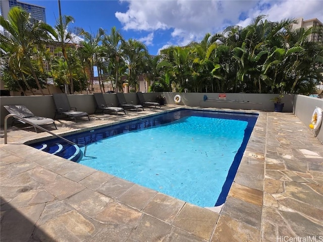 view of pool with a patio area, a fenced in pool, and fence