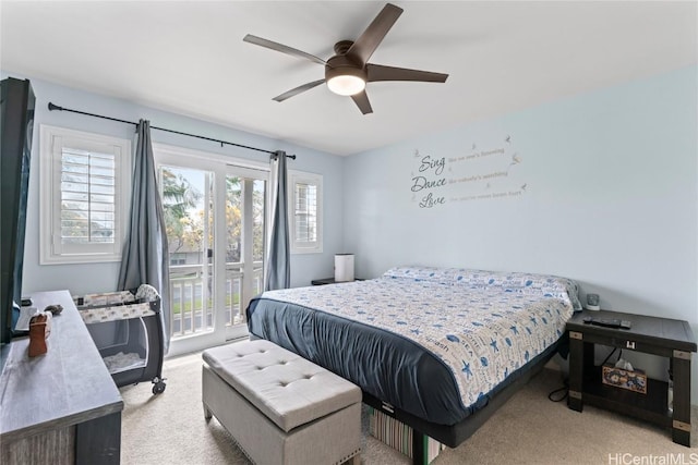 bedroom with access to outside, light colored carpet, and ceiling fan