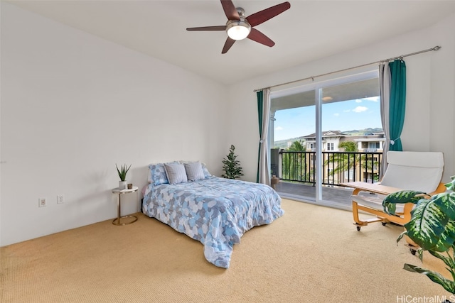 bedroom featuring access to exterior, a ceiling fan, and carpet