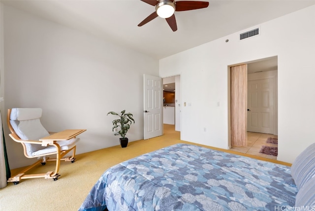 bedroom featuring light carpet, visible vents, and a ceiling fan