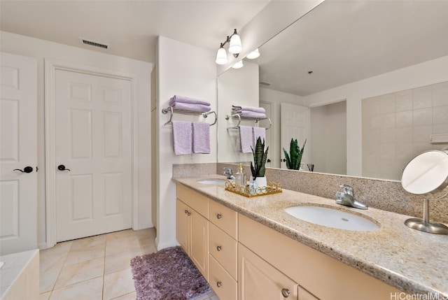 bathroom with tile patterned floors, double vanity, visible vents, and a sink