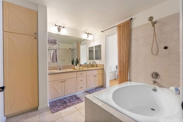 bathroom with a sink, tiled shower / bath combo, double vanity, and tile patterned flooring