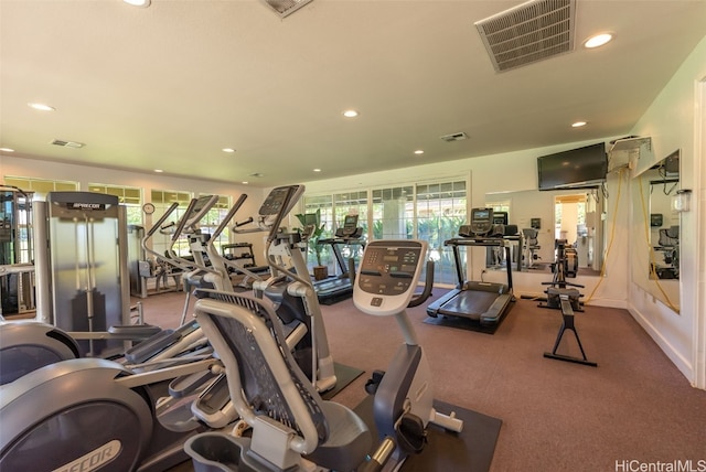 exercise room with recessed lighting, visible vents, and baseboards