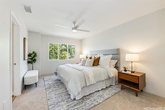 bedroom with light colored carpet, ceiling fan, and visible vents