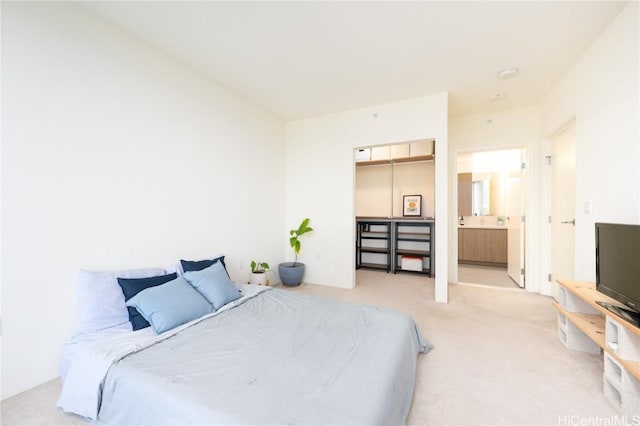 carpeted bedroom with a closet, a spacious closet, and ensuite bathroom