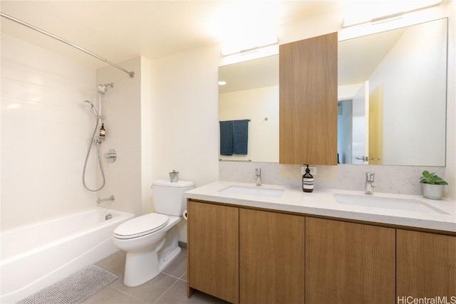 full bathroom featuring toilet, tile patterned flooring, double vanity, and a sink