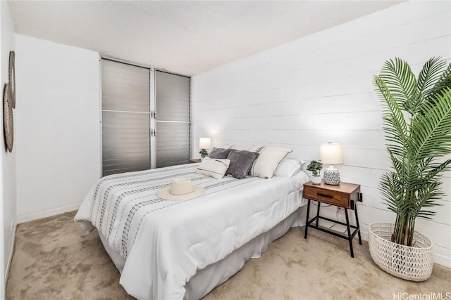 bedroom featuring light colored carpet and baseboards