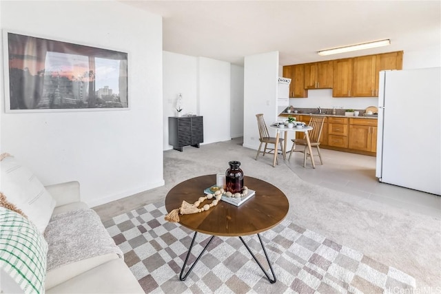 living area featuring light carpet