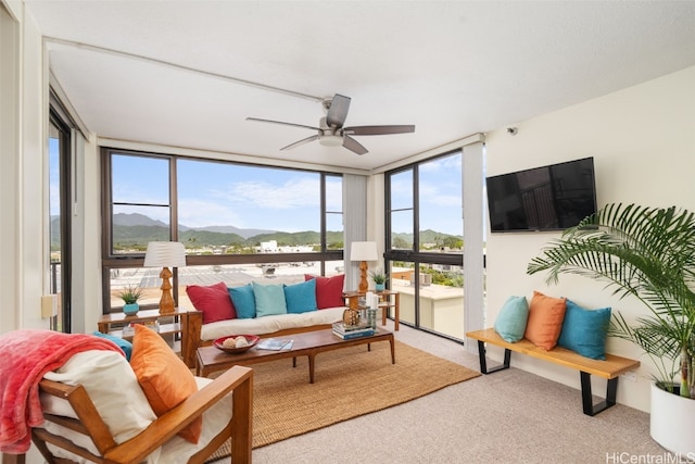 sunroom featuring ceiling fan