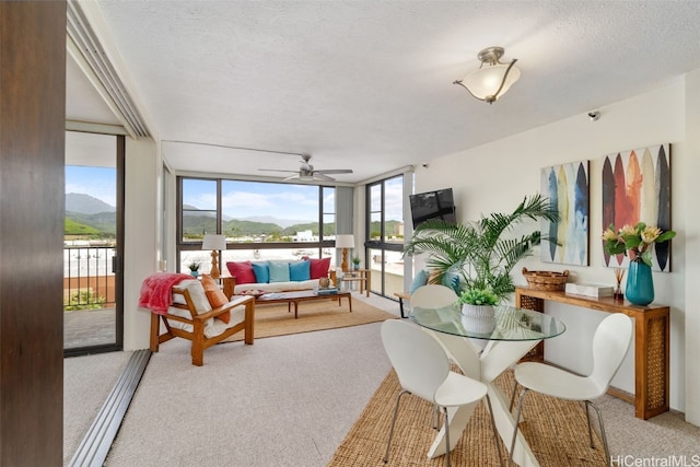 sunroom with a mountain view and ceiling fan