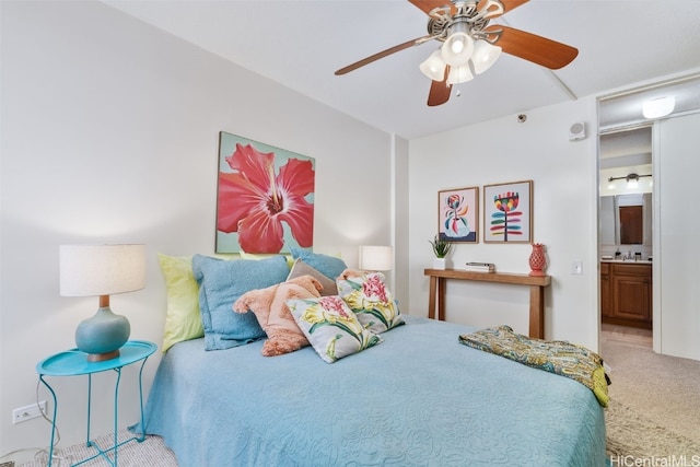 bedroom with carpet floors, connected bathroom, and a ceiling fan