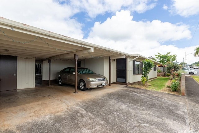 view of parking featuring an attached carport and driveway