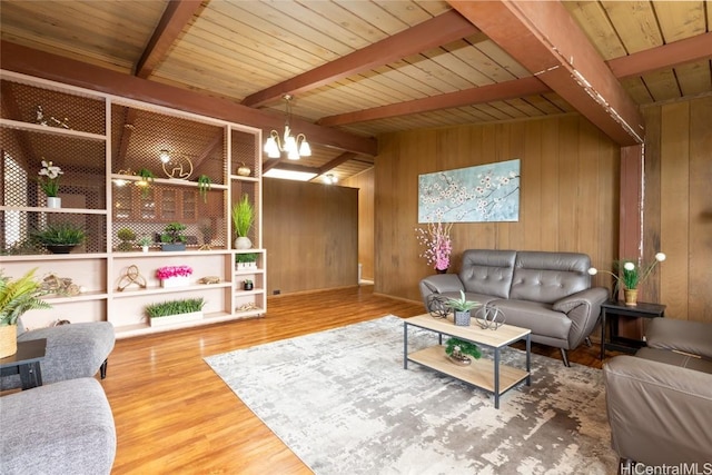 living area featuring wooden ceiling, a notable chandelier, wooden walls, and wood finished floors