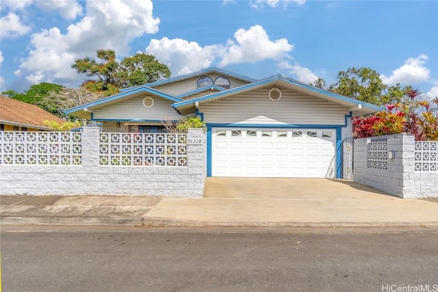 single story home with concrete driveway, fence, and an attached garage