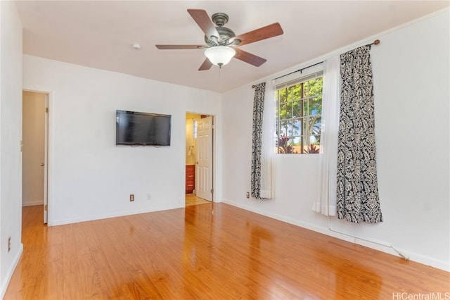 unfurnished living room featuring light wood-style flooring, baseboards, and ceiling fan