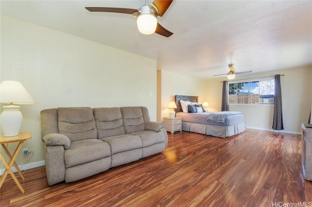 bedroom with a ceiling fan, baseboards, and wood finished floors