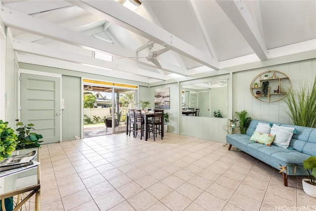 interior space with ceiling fan and vaulted ceiling with beams