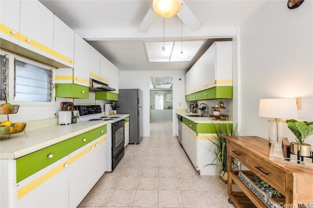 kitchen with appliances with stainless steel finishes, light countertops, under cabinet range hood, white cabinetry, and a sink