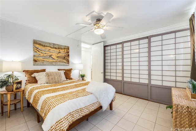 bedroom featuring light tile patterned floors and ceiling fan