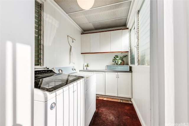 laundry area featuring independent washer and dryer and cabinet space