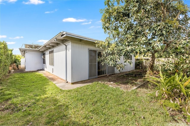 back of house featuring fence and a yard