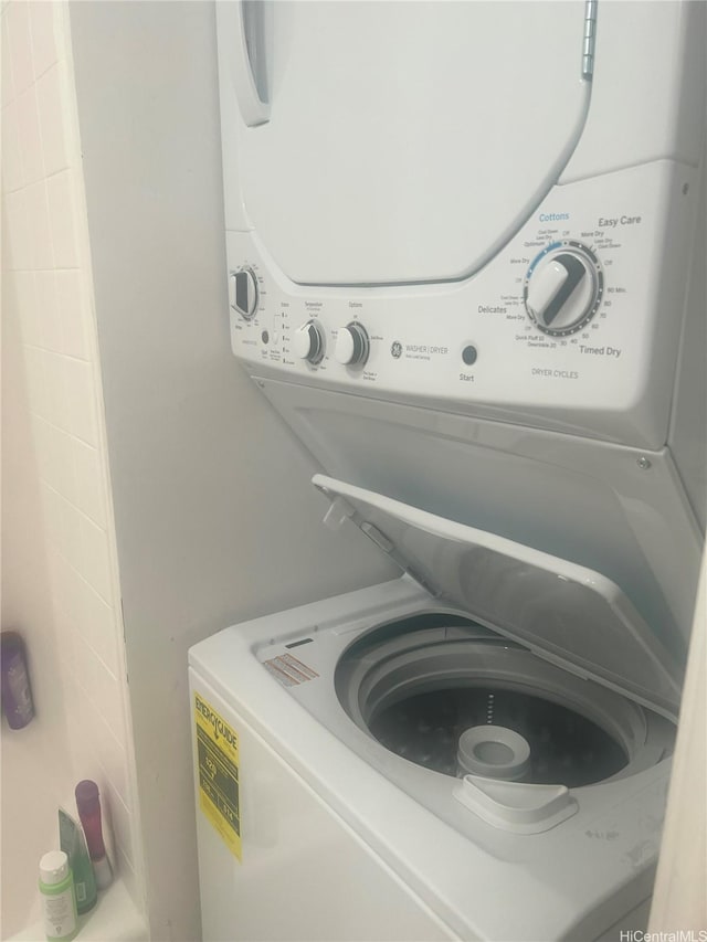 laundry area featuring stacked washer and clothes dryer and laundry area