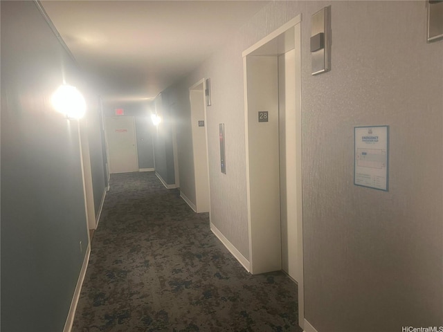 hall featuring elevator, baseboards, and carpet floors