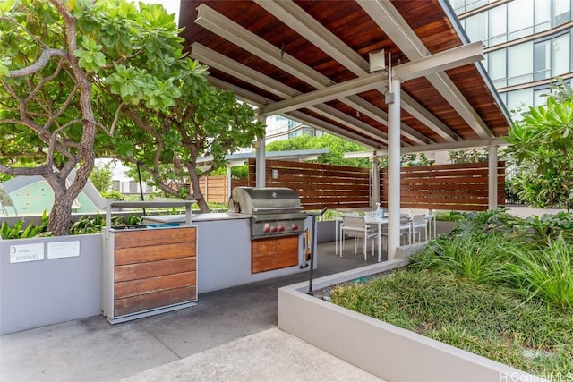 view of patio featuring fence, outdoor dining area, and area for grilling