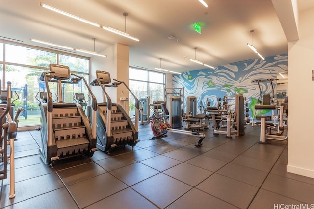 workout area featuring wallpapered walls and floor to ceiling windows