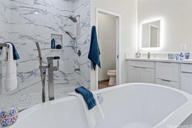 full bathroom with a marble finish shower, a soaking tub, vanity, and toilet