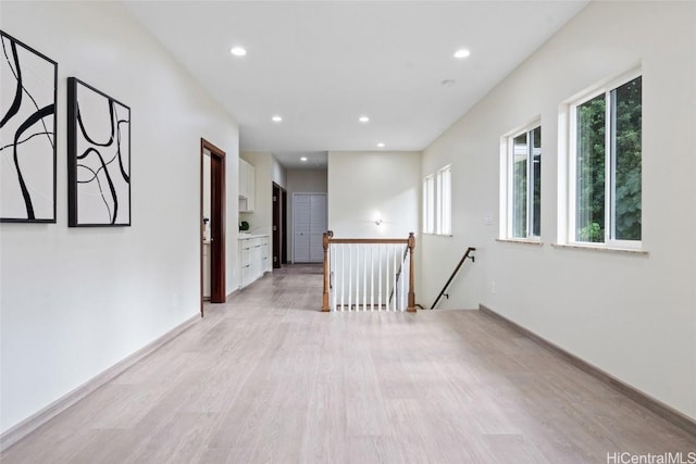 unfurnished room featuring light wood-type flooring, recessed lighting, and baseboards