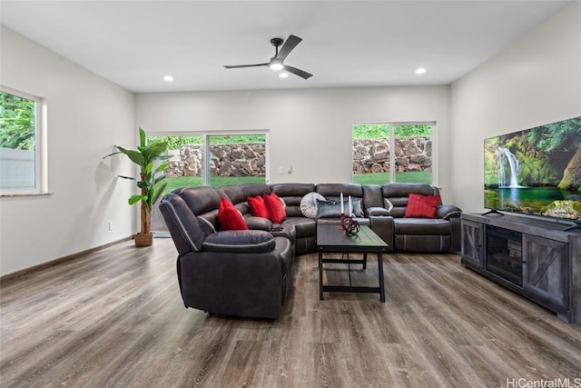 living room with recessed lighting, a healthy amount of sunlight, and wood finished floors