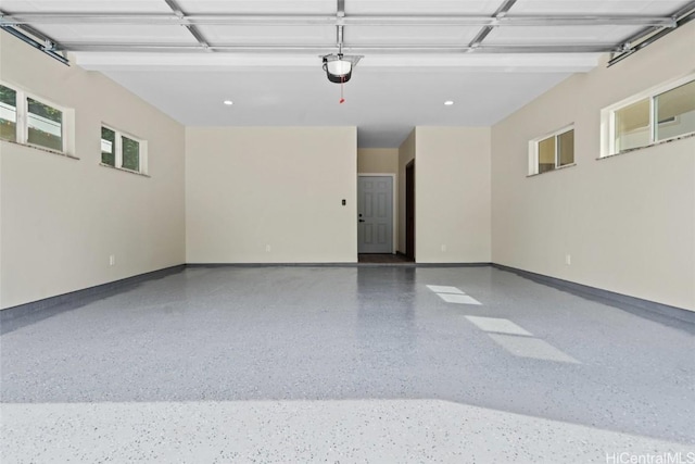 garage with baseboards and a garage door opener