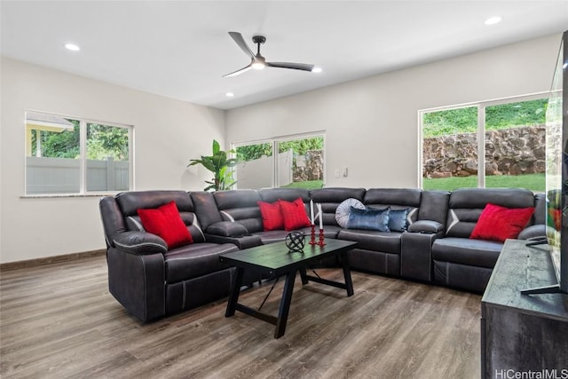 living room featuring a ceiling fan, recessed lighting, baseboards, and wood finished floors