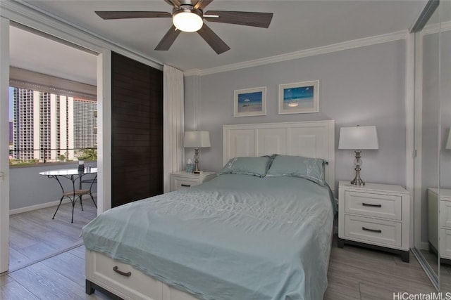 bedroom featuring ornamental molding, baseboards, light wood finished floors, and a ceiling fan