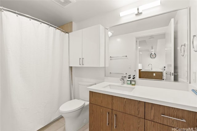 bathroom with toilet, tile patterned flooring, visible vents, and vanity