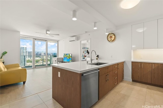 kitchen with floor to ceiling windows, open floor plan, a sink, dishwasher, and a peninsula