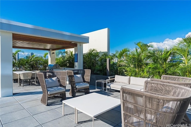 view of patio / terrace with an outdoor kitchen, outdoor lounge area, and a grill